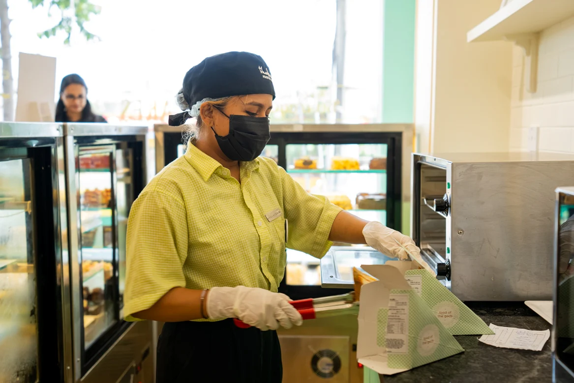Theobroma staff preparing an order with care